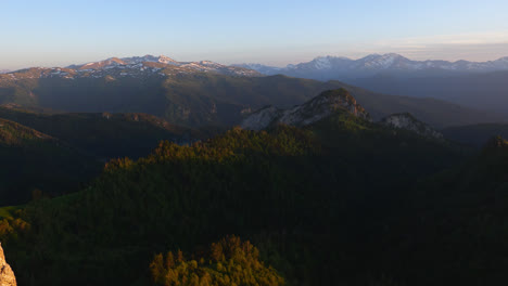 Panoramic-landscape-view-of-the-Caucasus-Mountains-valley-and-forest-from-above,-at-dusk