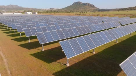 Backward-low-aerial-of-solar-panels-in-a-big-solar-farm-in-desert