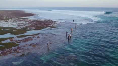 Bali-Fishermen-Fishing-on-Uluwatu-Ocean-Coast-in-Indonesia,-Aerial