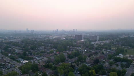Sunset-haze-blanketed-by-wildfire-smoke-causing-low-visibility-and-poor-air-quality-for-breathing-in-urban-city