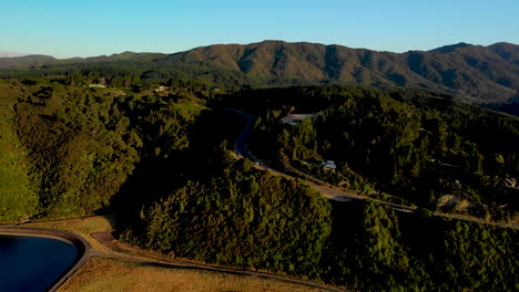 New-Zealand-State-Highway,-beside-Twin-Lakes,-landscape-reveal---aerial