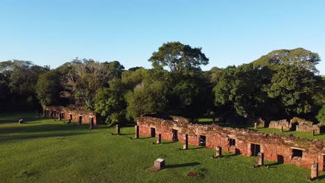Aerial-drone-panning-shot-footage-of-the-mission-ruins-of-San-Ignacio,-Argentina-amongst-a-beautiful-green-forest