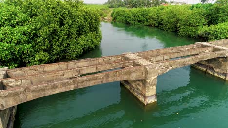 A-4k-aerial-shot-of-an-ancient-bridge-on-a-river