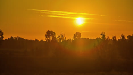 Bright-sunrise-above-green-vibrant-rural-landscape,-time-lapse-view