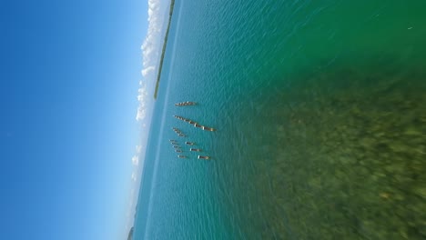 Vertical-drone-flight-over-Los-Haitises-National-Park-with-clear-water,islands-and-mountains