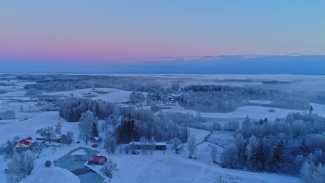 Freezing-day-over-rural-landscape-in-winter-season,-aerial-drone-view