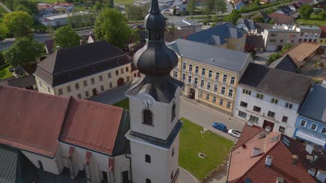 Village-church-bell-tower-Smooth-aerial-top-view-flight-Church-in-village-Heidenreichstein,-city-in-Austria-Europe,-summer-day-of-2023
