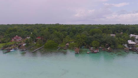 Overwater-Bungalow-Villas-on-Tropical-Bacalar,-Mexico-Coast---Aerial-at-Sunset