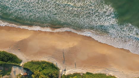 Aerial-top-down-view-tropical-beach-sunrise-with-golden-emerald-color-water