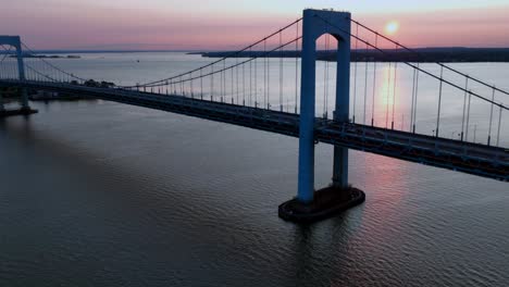 An-aerial-time-lapse-of-the-Throgs-Neck-Bridge-during-a-beautiful-sunrise,-seen-from-Queens,-New-York