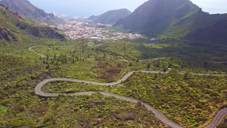 Aerial-perspective-shot-of-most-beautiful-travel-destination-of-Tenerife-near-Los-Gigantes,-Canary-Island,-Spain-featuring-small-township-valley-surrounded-by-lush-mountains