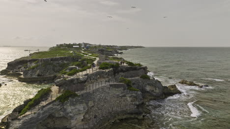 Isla-Mujeres-Mexico-Aerial-v18-low-drone-flyover-and-around-island-peninsula,-popular-tourist-attraction-Punta-Sur-park-and-natural-landscape-of-rock-formation---Shot-with-Mavic-3-Cine---July-2022