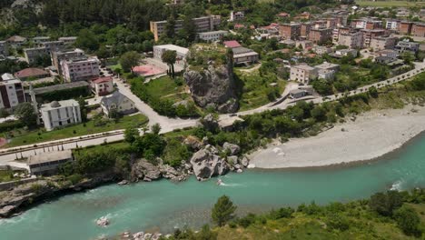 aerial-view-captures-the-beauty-of-Përmet,-a-small-town-in-southern-Albania,-on-a-sunny-day