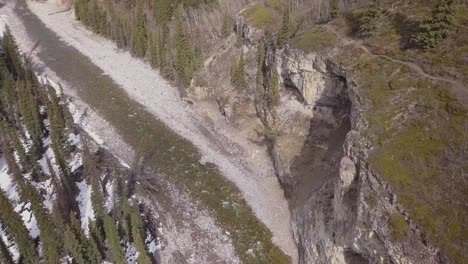 Rotating-aerial-view-of-a-boreal-river-canyon-in-spring