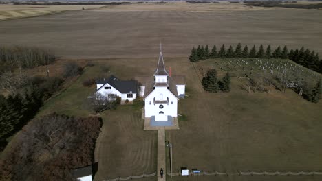 Backwards-flying-aerial-footage-revealing-pretty-St-Boniface-church-in-remote-location