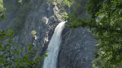 Static-shot-of-one-of-Venosc's-hidden-waterfalls-among-trees,-in-the-French-Alps