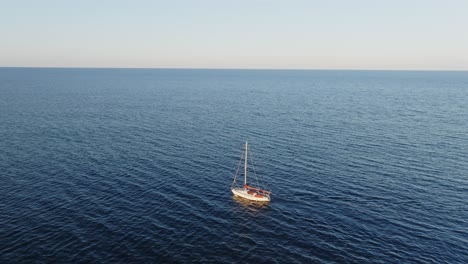 A-cinematic-aerial-view-of-a-boat-in-the-north-of-Menorca,-Spain