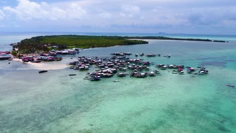 Pull-away-aerial-shot-of-a-Bajau-Laut-sea-nomad-community-at-Pulau-Omodal,-Sabah,-Malaysia