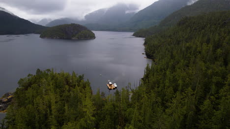 Epic-nature-setting-of-West-Coast-Floating-Sauna-on-Clayoquot-Sound,-surrounded-by-wilderness-Emerald-Edge-rainforest,-Tofino,-British-Columbia