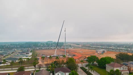 A-beautiful-4k-shot-of-a-crane-and-a-cellphone-tower-on-a-construction-site-down-south-in-the-united-states