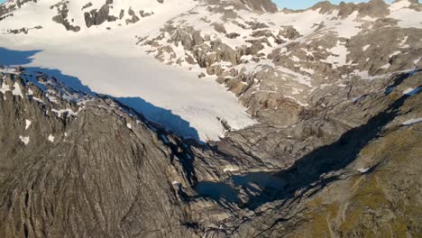 Amazing-birds-eye-view---Pristine-alpine-scene-of-glacial-lakes-under-glacier-and-frozen-snowy-peak