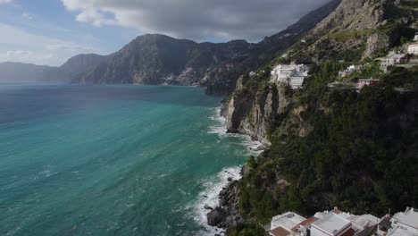 Luxury-white-hotel-and-condos-sit-on-cliff-side-of-beautiful-amalfi-coast