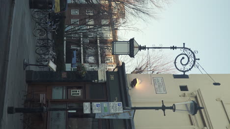 Vertical-Dolly-Left-Shot-of-Vintage-Lamp-and-Street-Sign-in-Portobello-Road