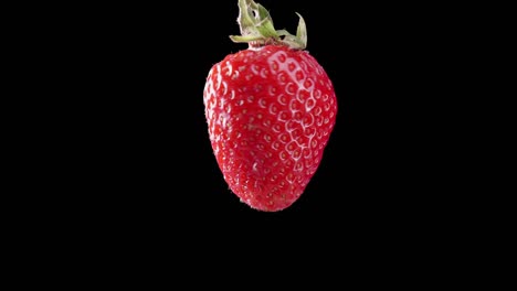 Spinning-strawberry-animation-with-a-seamless-loop-against-a-black-background