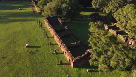 Aerial-arc-drone-footage-of-ruins-near-a-surrounding-green-forest-in-Argentina