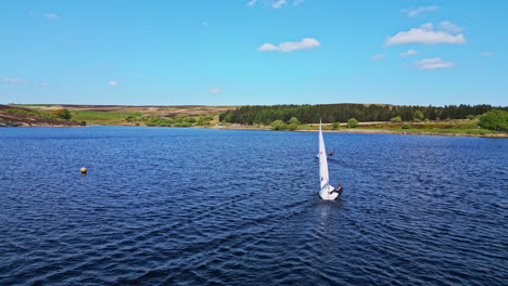 The-peaceful-Winscar-reservoir-in-Yorkshire-transforms-into-a-hub-of-excitement-as-small-one-man-boats-take-part-in-a-lively-sailing-event,-showcasing-the-sport's-leisurely-side