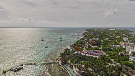Isla-Mujeres-Mexico-Aerial-v3-cinematic-drone-fly-along-the-coastline-capturing-beautiful-seaside-resorts-and-island-townscape-bounded-by-crystal-clear-sea-water---Shot-with-Mavic-3-Cine---July-2022