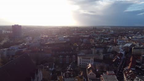 Aerial-circling-over-Braunschweig-downtown-at-golden-hour,-Germany