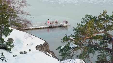 Bunch-of-ice-swimmers-going-into-water-on-a-cold-winter-evening