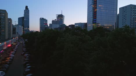 Aerial-revealing-shot-of-Warsaw-center-area-surrounded-with-modern-skyscrapers