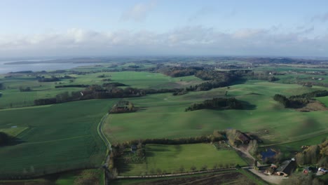 AERIAL:-Drone-footage-of-fields-and-forests-in-Jutland,-Denmark