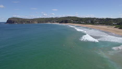 Surfers-On-Surfing-Board-Floating-In-The-Sea-At-The-MacMasters-Beach-Near-Copacabana-Beach-In-NSW,-Australia