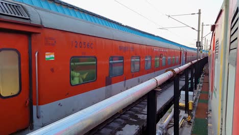 passenger-train-running-on-track-crossing-each-other-from-opposite-direction-at-morning-video-is-taken-at-new-delhi-railway-station-on-Aug-04-2022