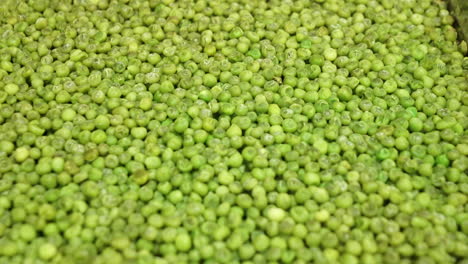 Closeup-of-green-peas-cooked-in-a-metal-tray-of-an-industrial-kitchen