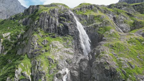 Drone-aerial-view-of-a-huge-waterfall-in-the-swiss-alps,-Obwalden,-Engelberg