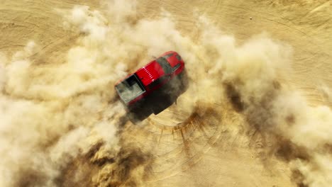 Red-four-wheel-drive-truck-spinning-donuts-in-the-desert-sand---straight-down-aerial-view