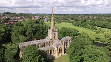 Establishing-low-aerial-view-from-Holy-Trinity-church-to-reveal-Stratford-Upon-Avon-countryside-English-town-landscape