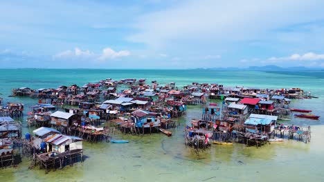 Revealing-landscape-drone-shot-of-Pulau-Omadal-with-Sea-houses-of-the-sea-nomads