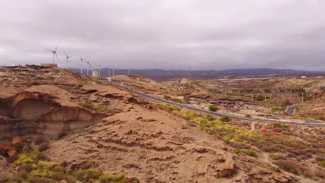 Desert-look-landscape-of-Tenerife-island-with-road-and-windmills,-aerial