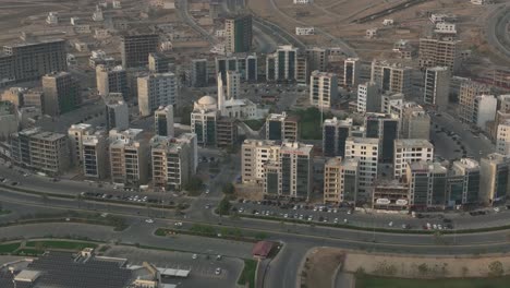 Aerial-drone-rotating-shot-over-a-newly-developed-planned-township-in-Bahria-town,-karachi,-Pakistan-on-a-sunny-day