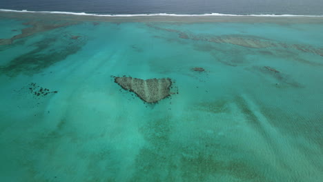 Aerial-parallax-around-Le-Coeur-de-Poé-or-Poé's-Heart,-Poé-Beach,-New-Caledonia