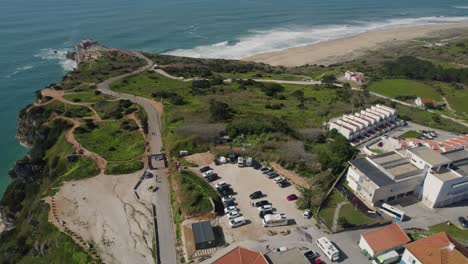 Nazare-cliff-landscape,-showcasing-the-Road-of-Angels-that-leads-up-to-the-top-of-the-cliff,-the-Estacionamento-car-park,-and-other-nearby-buildings