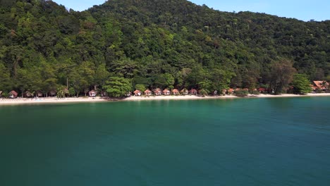 Perfect-aerial-view-flight-Cabins-huts-on-jungle-white-sandy-beach-island-koh-chang-thailand-2022