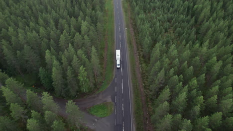 Aerial-Bird-View-of-Forest-Road-in-Finland,-White-Truck-Passing-By,-Traffic,-Summer,-Overcast-Day
