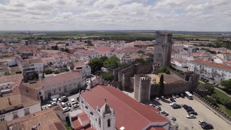 Flyover-Beja-Cathedral-and-Castle,-city-buildings-in-Background