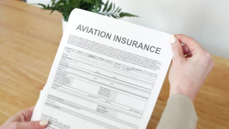 A-woman-opening-a-aviation-Insurance-Document-letter-outlining-her-policy-and-cover-details